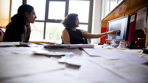 People collaborating in front of a computer