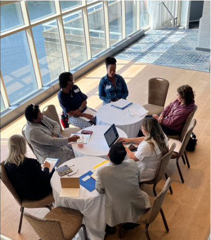 District leaders discussing implementation plans around a table